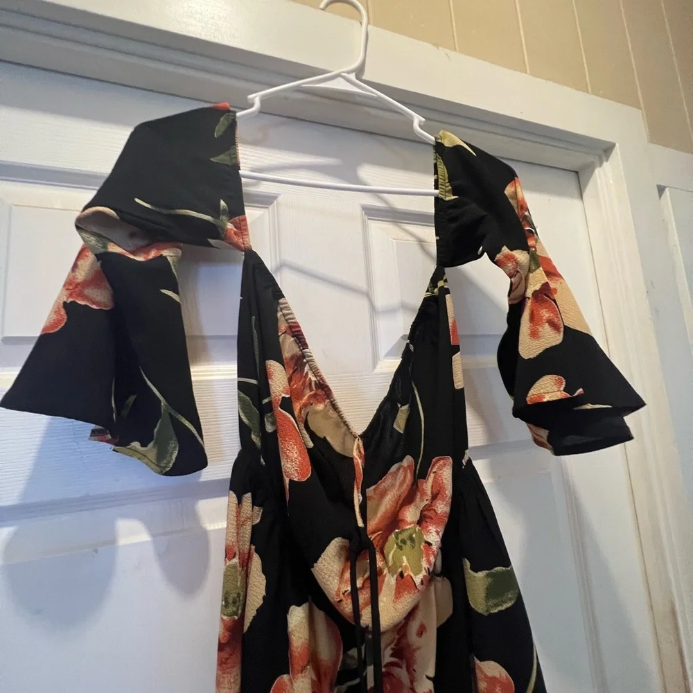 NWOT. Black flowy floral off the shoulder 3/4 sleeve romper. - Picture 6 of 11